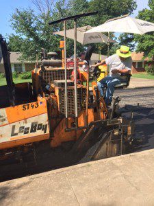 Employees working on re-pavement by Hoover School District